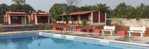 Picture Showing overview of cottages & swimming pool at Farm House at Karjat